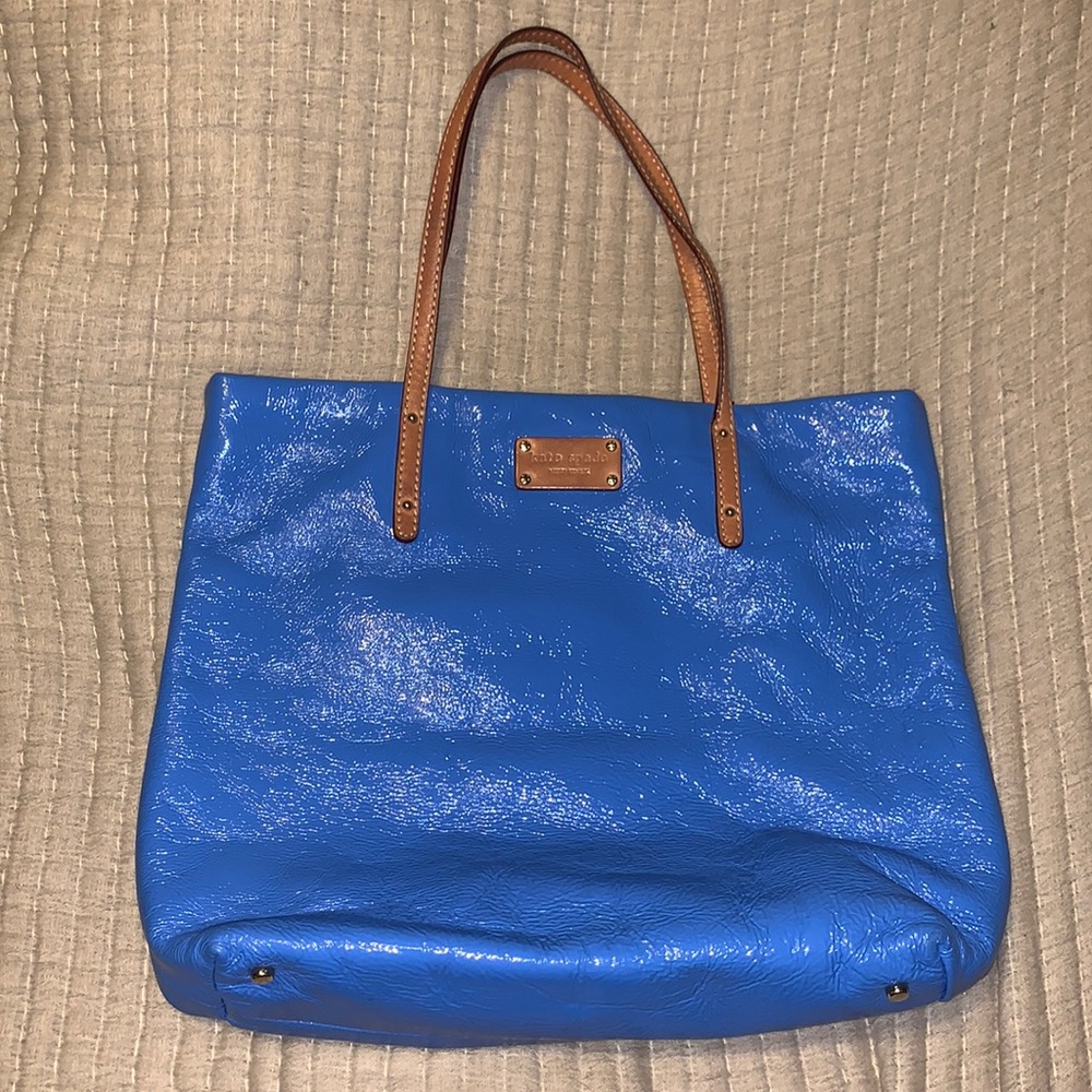 Blue textured Kate Spade tote bag with leather straps and magnetic closure